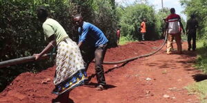 Residents of two villages in Kandara Sub County dig trenches for a government project