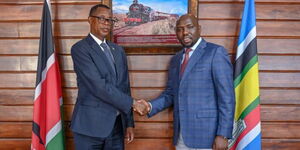 Transport CS Kipchumba Murkomen (left) shakes hands with Rwanda's Minister of State for Foreign Affairs in Charge of Regional Cooperation Gen (Rtd) James Kabarebe at Transcom House, Nairobi, on Friday, February 17, 2024