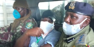 Former Machakos Senator Johnstone Muthama sandwiched between police officers during his arrest on December 15, 2020