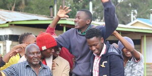 Clinton Mutwiri celebrates with his colleagues at Angaine Day Secondary School in Meru on April 23, 2022.