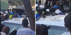 Onlookers witness as police officers load the bodies of two people onto their van along Moi Avenue in Nairobi CBD on Tuesday, December 9, 2025.