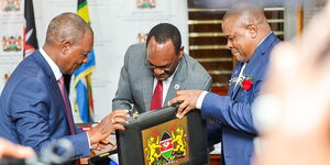 Treasury Cabinet Secretary Njuguna Ndu'ngu (left) and Treasury Principal Secretary Chris Kiptoo (centre) preparing to submit proposed budget to the National Assembly 