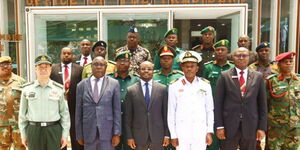 Interior PS Raymond Omollo (centre) poses for a photo alongside a delegation of ten-course members from the National Defence College (NDC) outside Interior Ministry offices on April 18, 2023. 