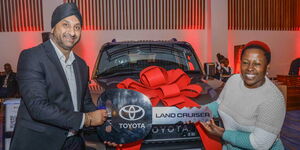 CFAO Mobility Kenya Managing Director, Arvinder Reel (Left) hands over the keys to the brand New Generation Land Cruiser Prado to Ambassador Catherine Wambugu (Right) who is the latest owner of the new car.