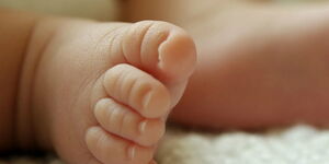 Feet of a newborn baby in a hospital.