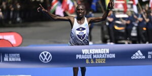 An image of Nobert Kigen, crossing the finish line as he won the Prague international marathon in 2022