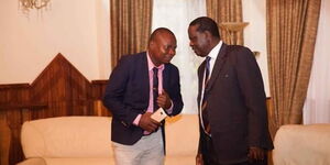 ODM Comms Director Phillip Etale speaks to the party's leader Raila Odinga.