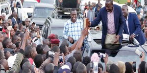 Deputy President William Ruto receives a Bible gift from one of his supporters at Mosoriot, Nandi County on March 13, 2020. 