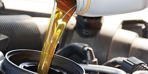 Photo of synthetic oil being put on a car engine