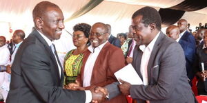 President William Ruto(Left)shaking hands with Busia Senator Okiya Omutata(Right) during a thanksgiving service in Busia on May 25, 2023.