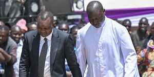 Kapseret Member of Parliament Oscar Sudi walking side by side with a priest during his aunt's burial ceremony n Saturday, September 20, 2025.