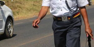 A police officer walks away after inspecting a vehicle along Jogoo Road in Nairobi in March 2022.