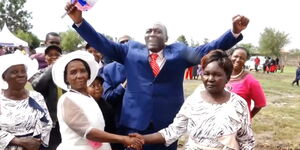 Patrick Ndacu and his two wives, Margaret and Dinah, shake hands after wedding.
