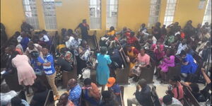 Congregants covering their noses using handkerchiefs as fumes from used tear gas canisters spread inside the PCEA church in Kariobangi North, Nairobi on Sunday, November 30, 202