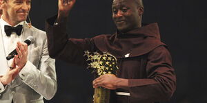 Kenyan teacher Peter Tabichi, right, reacts near actor Hugh Jackman, after winning the $1 million Global Teacher Prize in Dubai, United Arab Emirates, March 24, 2019.