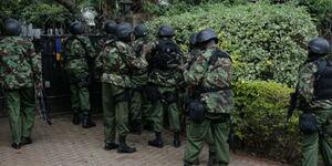 General Service Unit (GSU) officers pictured outside a gate in Lavington, Nairobi before a raid in November 2013