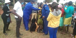 Police rescue UDA ward representative candidate Caroline Muriithi who was being ejected out of a rally in Kirinyaga county on June 21, 2022.