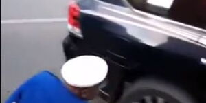 Traffic Officer Attempts to Deflate Tyre of a Fleeing Car on November 3, 2020.