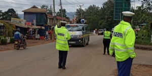 Police officers flag down a bus during a crackdown on Thika Road.