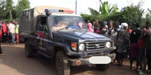 Police van carries away the body of teacher who was found hanging at a kiosk in Kisii on April 7