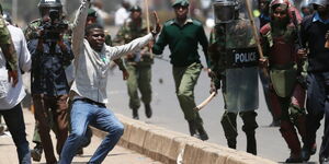 An image of police officers chasing after a protestor at a past event.