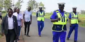 Police officers and locals visit the scene of an accident in Juja, Kiambu County, on May 6, 2023.