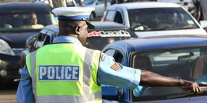 A traffic police officer controlling vehicles along Mombasa Road in Nairobi on February 28, 2023.