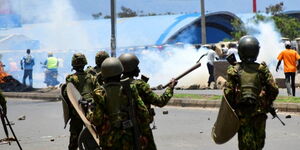 Police officers calming protestors during a riot in Nairobi on Thursday March 30, 2023