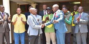 President William Ruto (center) watches as Senator Boni Khalwale greets Cleophas Malala.