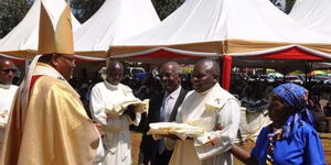 Reverend Michael Mithamo King'ori (right) being ordained by Archbishop Anthony Muheria at Kiamuiru Catholic Parish, St. John Bosco Kiamuiru Primary School Grounds on January 14, 2023