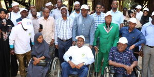 A photo of persons living with disabilities alongside leaders during a project launch 