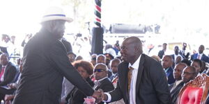 Former Prime Minister Raila Odinga greeting Deputy President Rigathi Gachagua during the funeral of late freedom advocate Mukami Kimathi on Saturday May 13, 2023