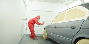 A car at a mechanic shop being repainted