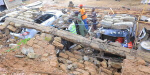 Residents attempt to salvage cars damaged after wall collapses in Kitui