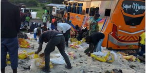 Residents of Othoo salvaging sugar remains strewn on the road after an accident in Ahero, on January 29