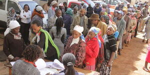 Former government employees in a queue to collect their retirement benefits at a past event. 