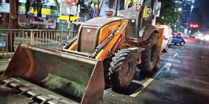 Road contractors recarpeting Moi Avenue at night 