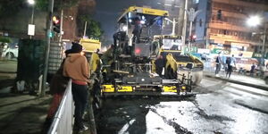Road contractors recarpeting Moi Avenue at night 