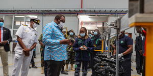 President Uhuru Kenyatta being taken through gun parts at the Ruiru Small Arms Factory on April 8, 2021