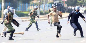 Anti-riot police corner a demonstrator during the protests in Nairobi on May 16, 2016. 