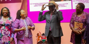 President trying on a hat gifted to him by women governors at Safari Park on March 8, 2024.