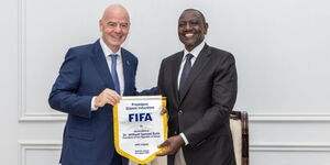 President William Ruto receiving a pennant exchange from CAF President Dr Patrice Motsepe at State House, Nairobi, as FIFA President Gianni Infantino looks on, on August 29, 2025. 