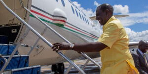 President William Ruto boarding a plane as he jets out of the country