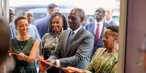 President William Ruto (centre) cuts the ribbon during the Vivo Fashion Group’s store launch in Atlanta on May 21, 2024. He was accompanied by First Lady Rachel Ruto (right).