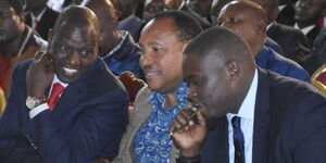 Deputy President William Ruto consults former Kiambu Governor Ferdinand Waititu and Nairobi Senator Johnson Sakaja at an event in 2019.