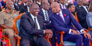 President William Ruto conversing with Public Service Cabinet Secretary Moses Kuria during the funeral Service of the latter's sister in Gatundu South, Kiambu County on January 23, 2023.