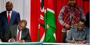 President William Ruto(left) and the late Former Prime Minister Raila Odinga signing the 10-point agenda at KICC on March 7, 2025