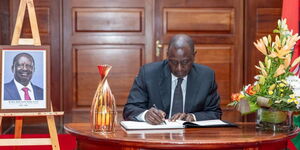 Ruto signing Raila condolence book