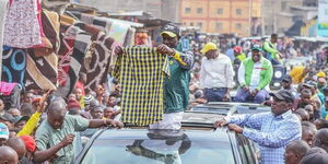 The then Deputy President William Ruto looks at a shirt at Gikomba Market in July 2022 during the campaigns for the August General Election.