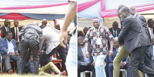 A man is whisked away by security team after he ran holding a document to the President-elect William Ruto's seat at Larmudiac High School in Njoro Sub County, Nakuru County.